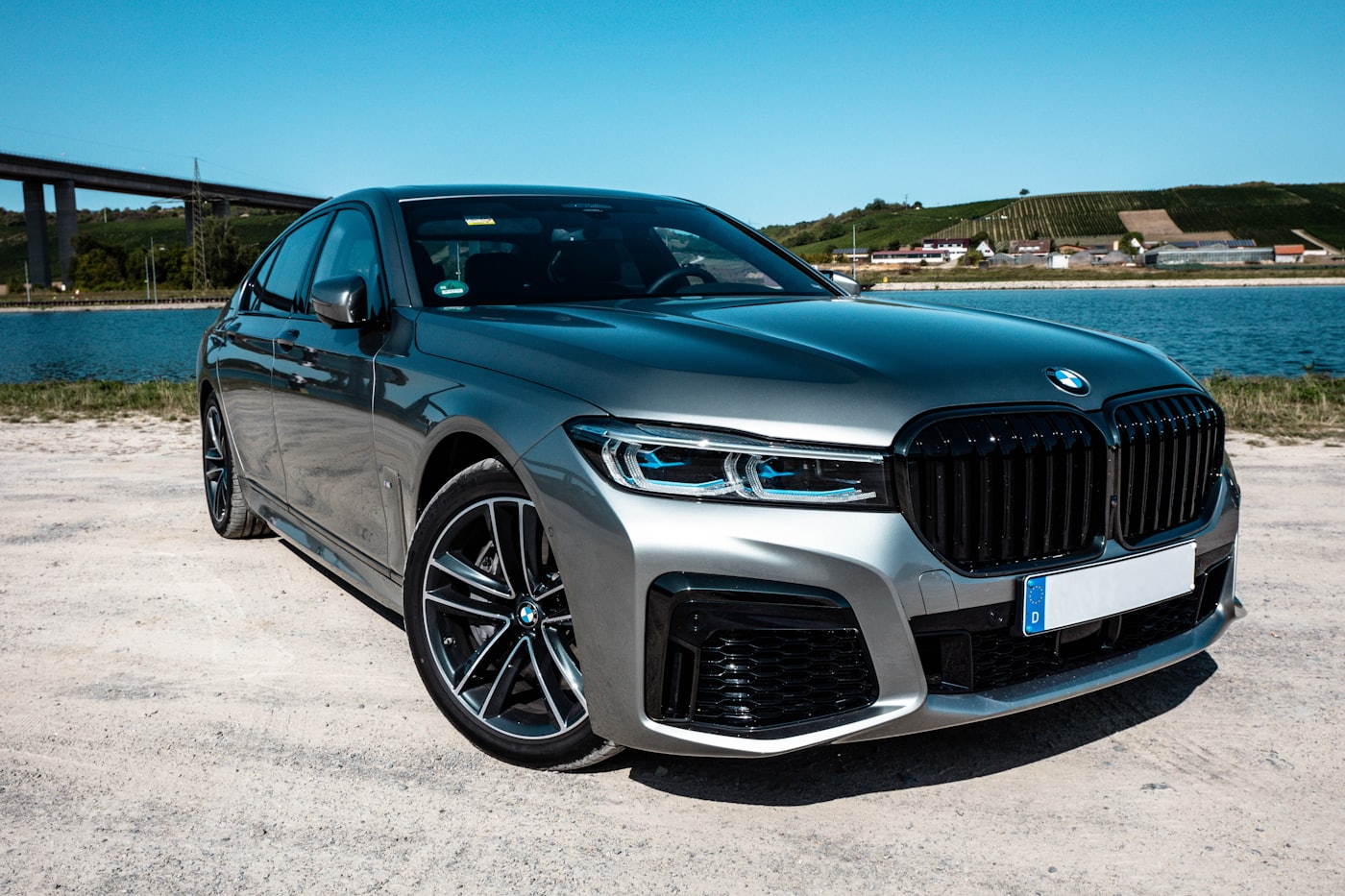 After: a spotless gray BMW parked by the water on a sunny day following a DnA detail